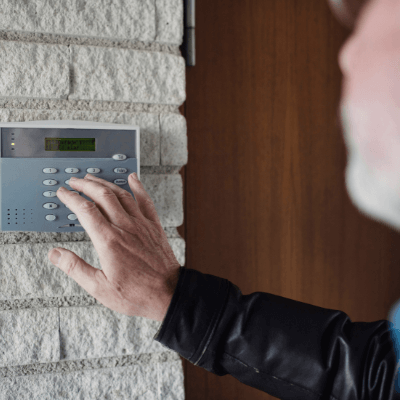 Man protecting him home by setting his home alarm
